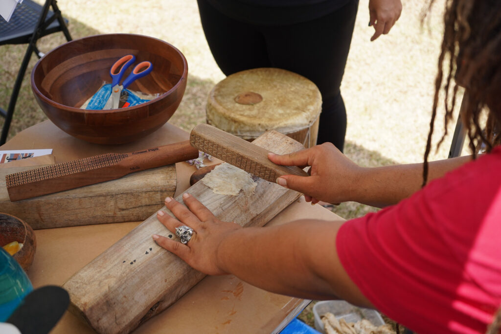 Kapa making by pounding wauke bark.